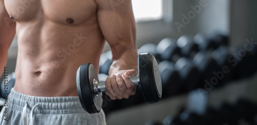 Bodybuilder man lifting weights in the sport gym, close up ,bodybuilding and muscle building concept.