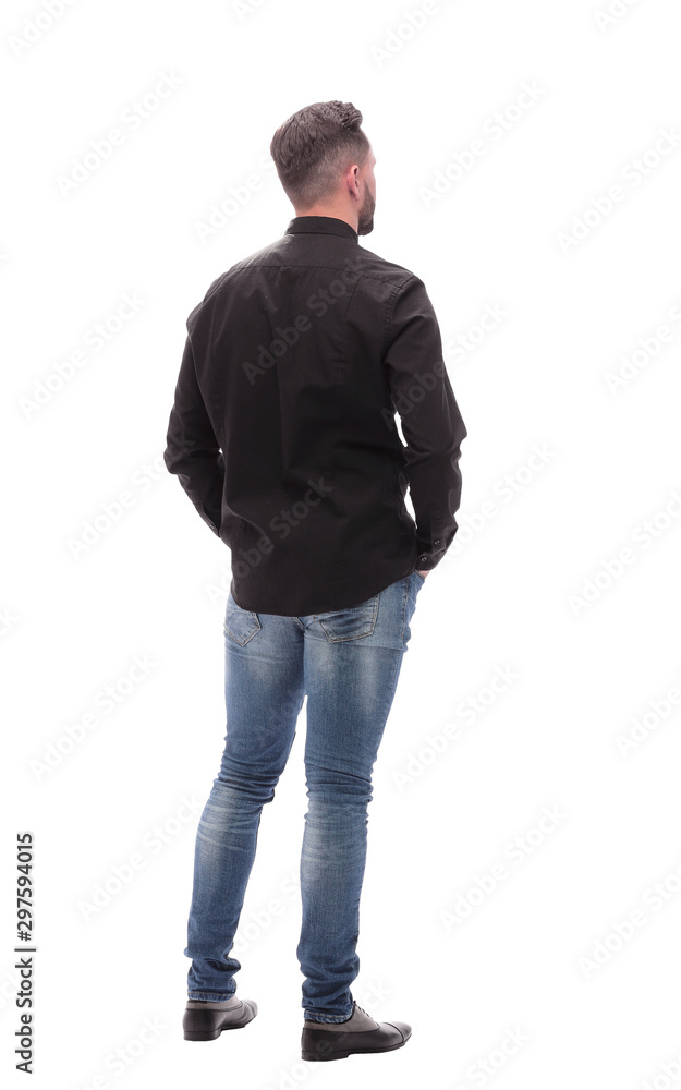 rear view. young man in jeans looking forward rear view. young man in jeans looking forward