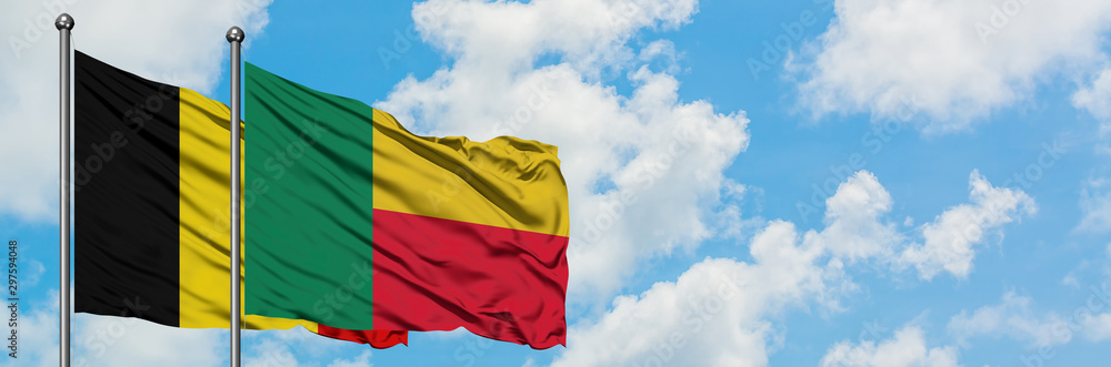 Obraz premium Belgium and Benin flag waving in the wind against white cloudy blue sky together. Diplomacy concept, international relations.