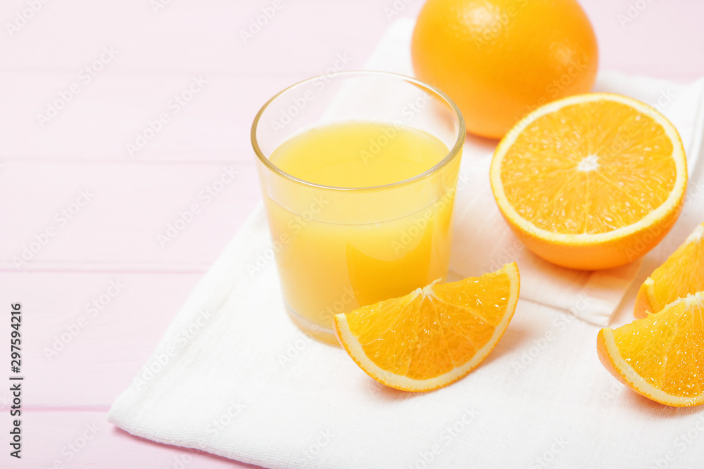 Orange juice in a glass, oranges and orange slices on the table. Orange juice in a glass, oranges and orange slices on the table.
