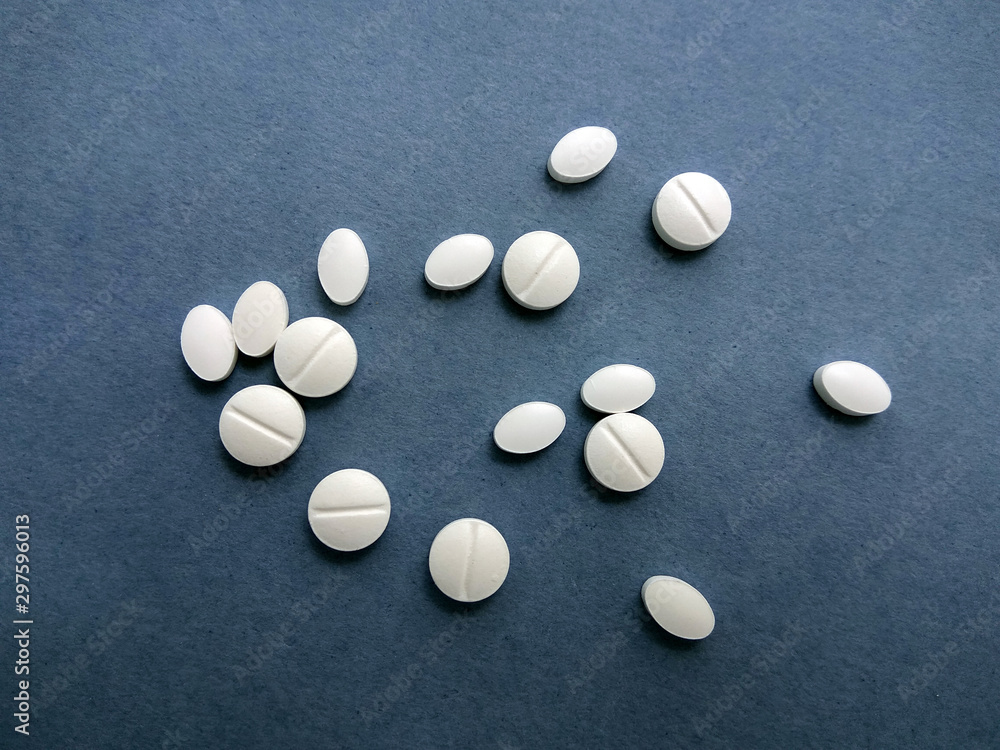photo white pills on a blue background