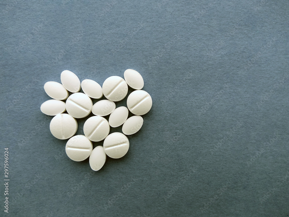 photo white pills on a blue background