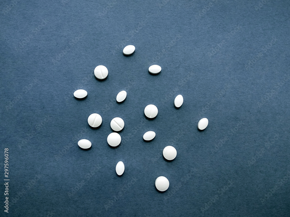 photo white pills on a blue background