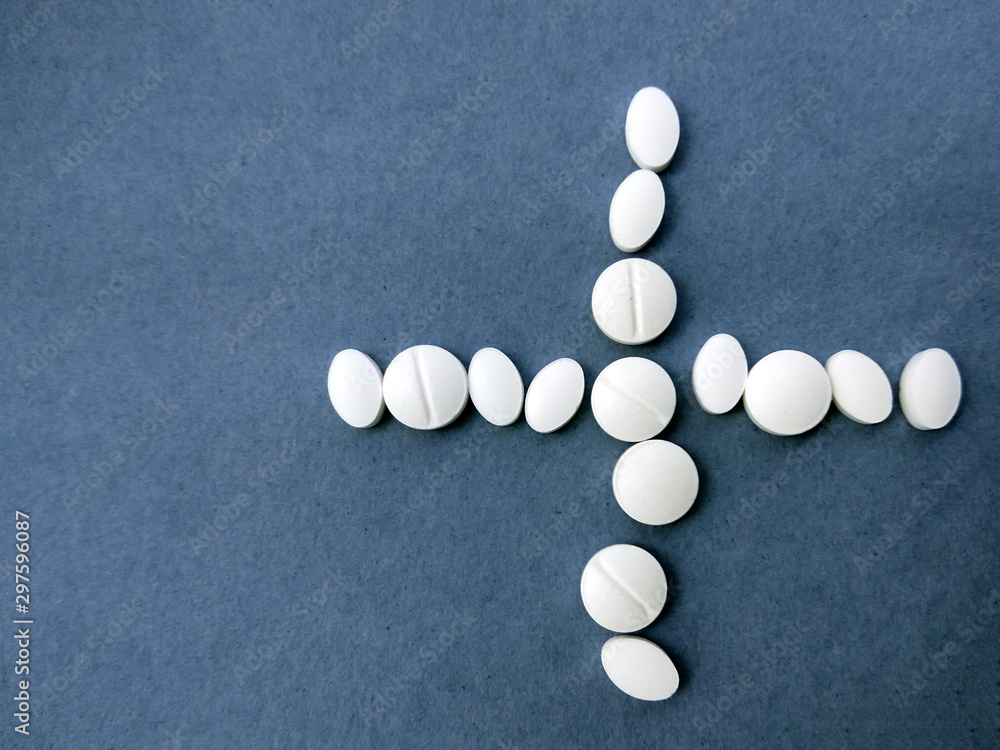 photo white pills on a blue background