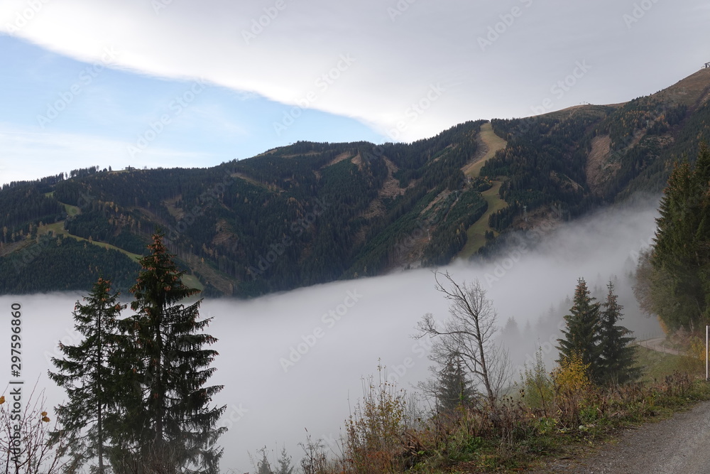 autumn in the mountain with fog in the valley