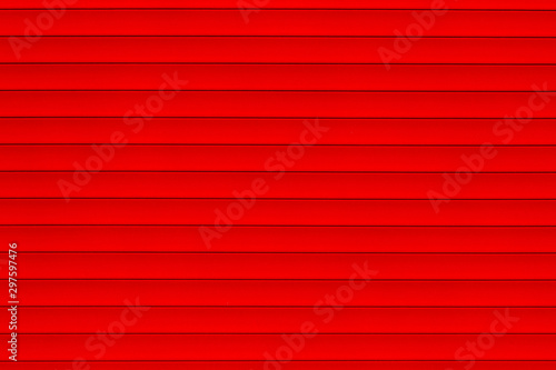 Abstract red texture background. Red wall background. Striped background. Colorful fence, cropped shot. 