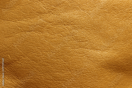 Blurred leather background, ocher color. Abstract texture background out of focus. Abstract light-brown background.