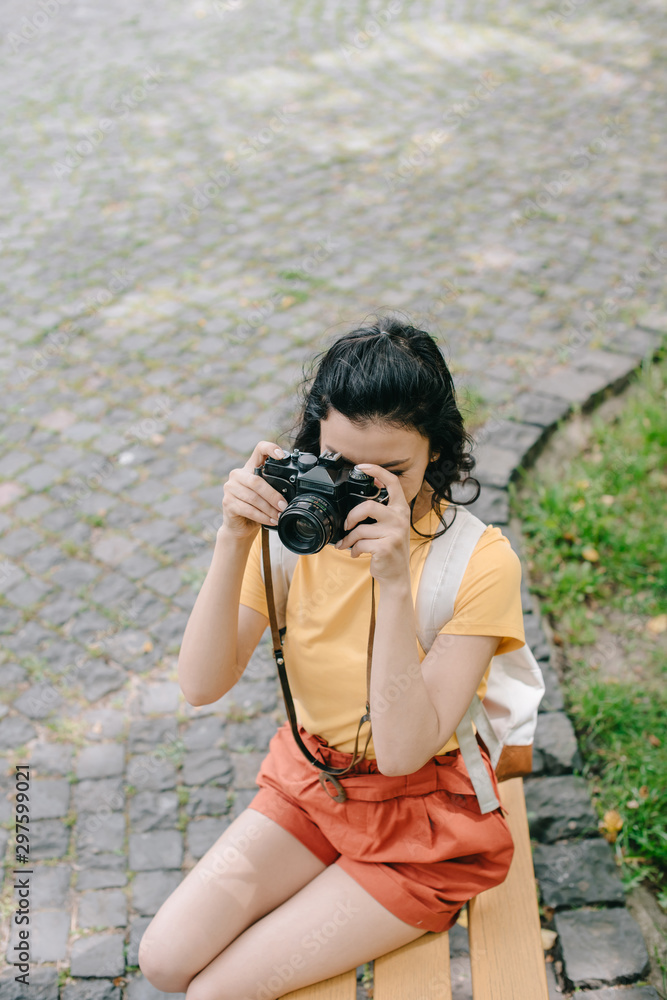 overhead view of girl taking photo on digital camera outside overhead view of girl taking photo on digital camera outside