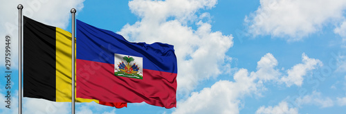 Εκτύπωση καμβά Belgium and Haiti flag waving in the wind against white cloudy blue sky together