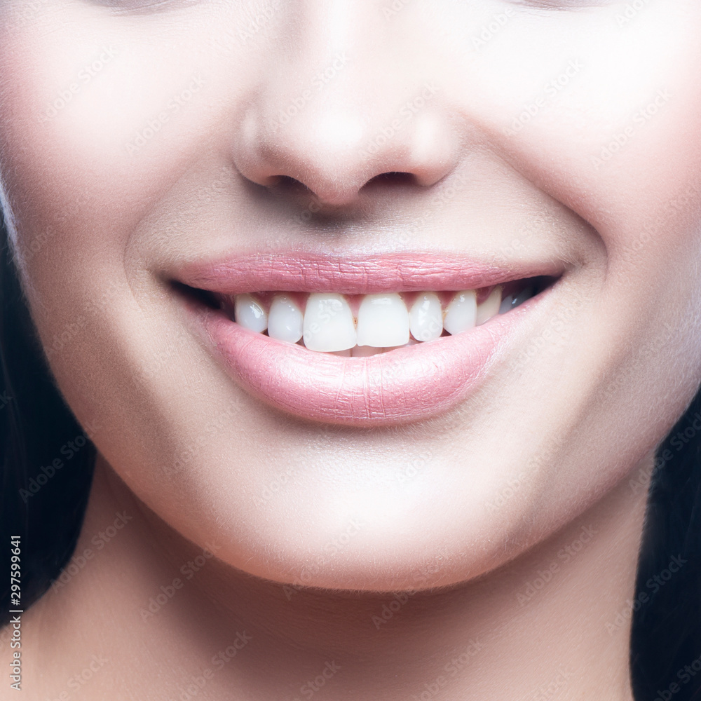 Lips, face, smile of beautiful model woman. Partial beauty young woman portrait. Healthy perfect skin, nude natural makeup. Isolated. White background. Skincare facial treatment body care concept Lips, face, smile of beautiful model woman. Partial beauty young woman portrait. Healthy perfect skin, nude natural makeup. Isolated. White background. Skincare facial treatment body care concept