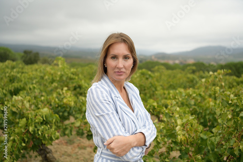 Woman looking at the camera in a vineyard