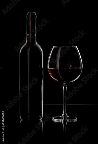 bottle and wine glass with red wine