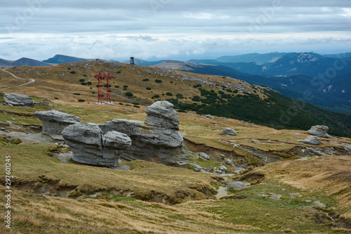 Huge sphinx-like stone in the Bucegi Natural Park in Romania. Megaliths on top of a mountain range, tourist attraction.