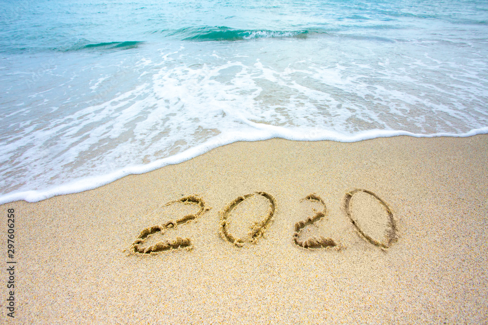 New Year 2020 on the sandy shore against the backdrop of sea waves.