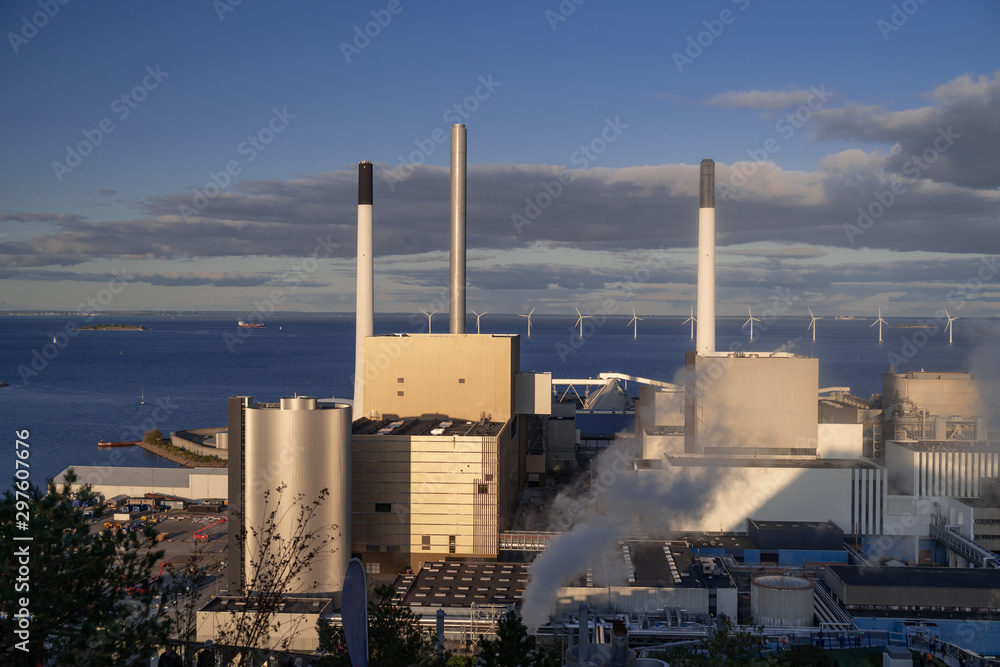 View of the plant from the outside, pipes smoke, wind turbines in the sea, barrels, tanks, thermal power plant, modern, technological waste processing plant, garbage processing plant View of the plant from the outside, pipes smoke, wind turbines in the sea, barrels, tanks, thermal power plant, modern, technological waste processing plant, garbage processing plant