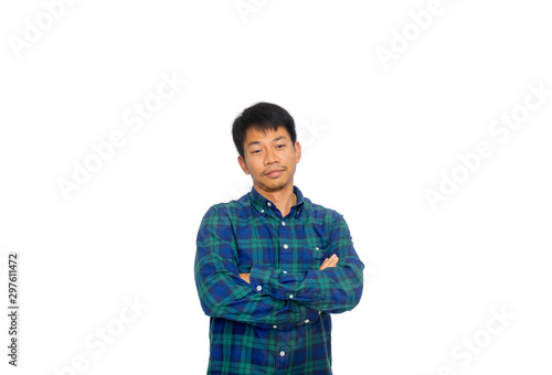 Φωτογραφία An Asian untidy man in blue plaid shirt is crossing his arms and looking down to the floor thinking of something