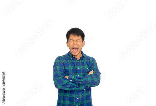 An Asian untidy man in blue plaid shirt is crossing his arms and yawning.