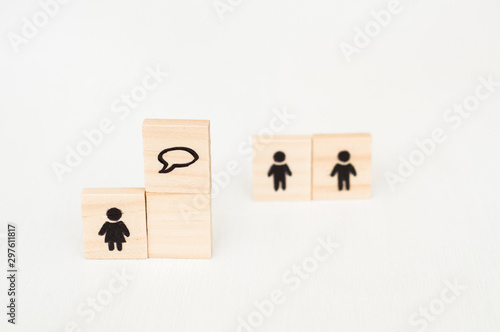 Wooden figures on white background. Business couch concept. Gender