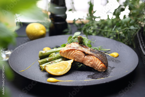 Grilled salmon on green asparagus. An elegant exquisite dish. photo