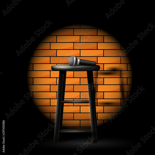 Stand up comedy show - microphone on stool in ray of spotlight and brick wall