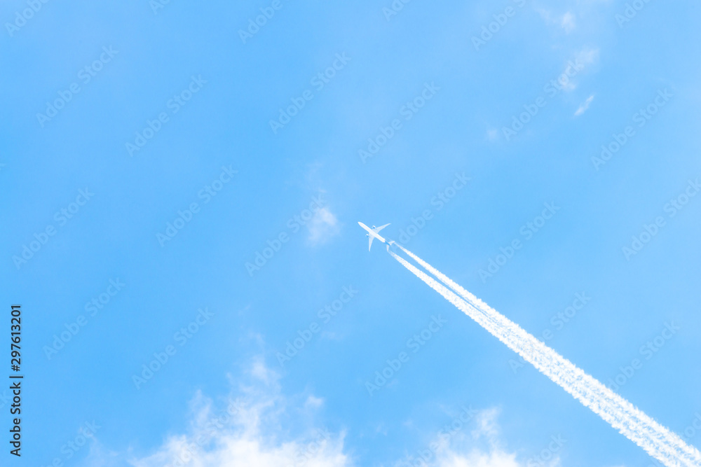 Airplane in a blue sky with clouds and condensation trails, Germany Airplane in a blue sky with clouds and condensation trails, Germany