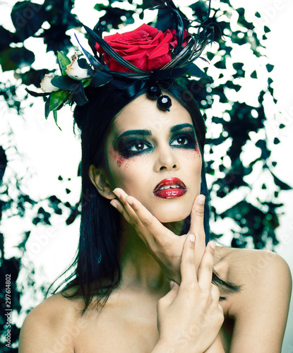 Fototapeta Naklejka Na Ścianę i Meble -  pretty brunette woman with rose jewelry, black and red, bright make up a vampire closeup red lips