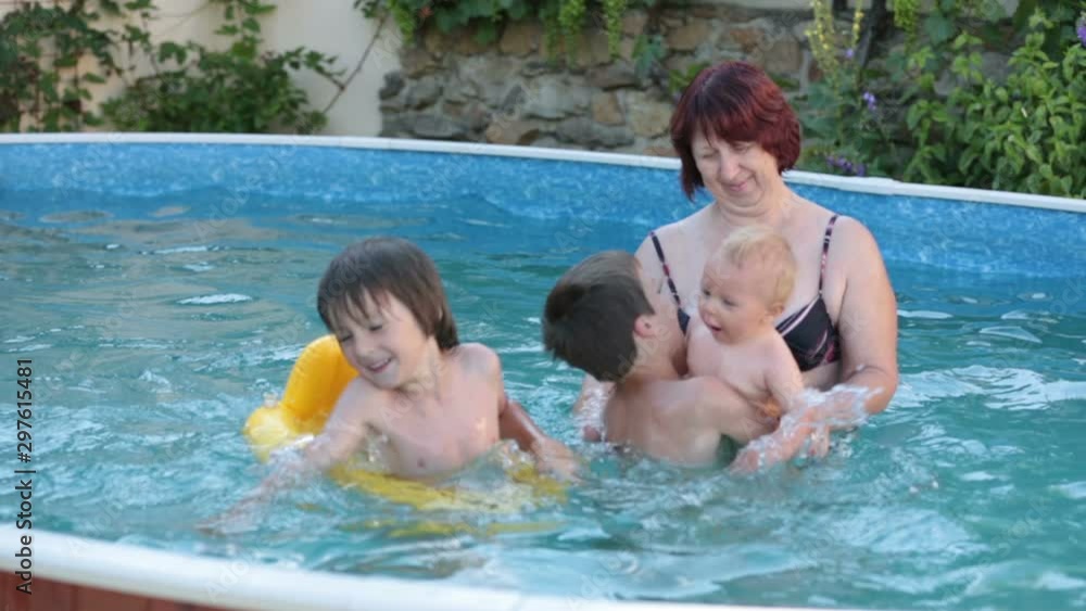 Baby boy, swimming in big swimming pool, enjoying the hot weather Baby boy, swimming in big swimming pool, enjoying the hot weather