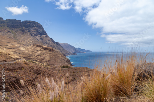 Coastline view down the west coast of Gran Canaria on a sunny and almost cloudless day with a quiet calm ocean. This area is part of Tamadaba National Park. photo