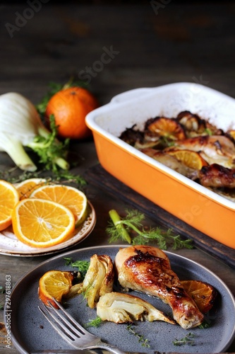 dish with fennel. Baked chicken drumsticks with fennel and oranges. festive dish, popular in the Mediterranean. Keto diet dish. ceramic baking dish.