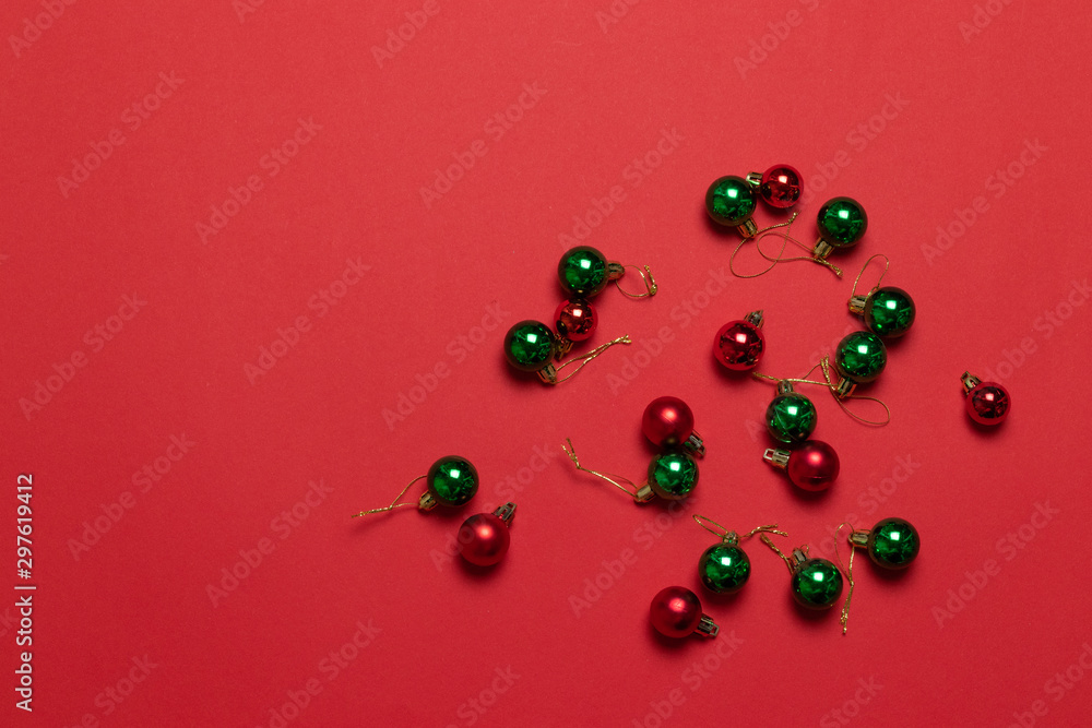 Multicolored classic christmas little balls on red background