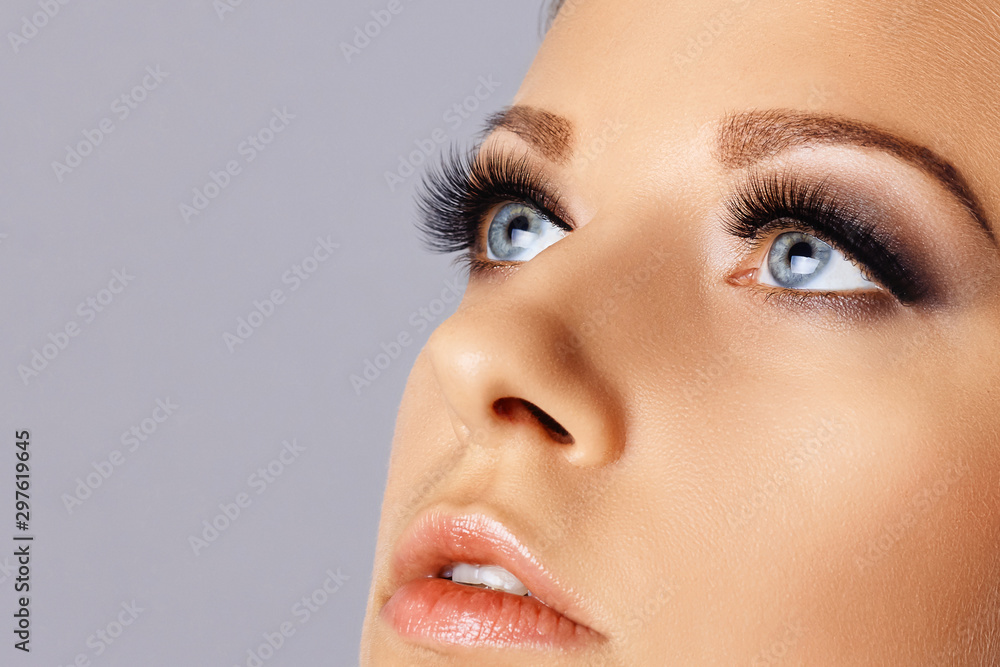 Fototapeta premium Woman face with eyes with long eyelashes and smokey eyes make-up. Eyelash makeup, cosmetics, beauty