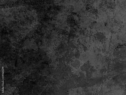 Dark gray concrete wall texture with cracks as background for designs.