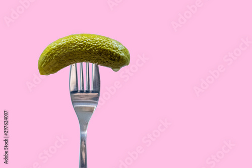 Pickle on fork, dill, gherkin, pink background, national pickle day	 photo