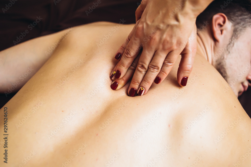The massage therapist's hand spreads the body essential oil The massage therapist's hand spreads the body essential oil