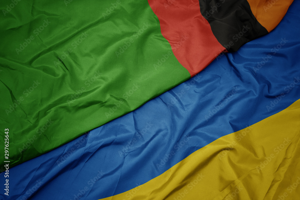 waving colorful flag of ukraine and national flag of zambia.