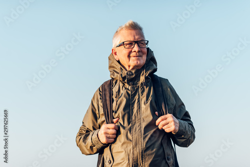 Senior man trail hiking in a mountain forest