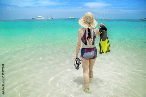 Cute girl is relaxing in the summer at the sea.Lovely girl is happy on the sand.Traveling by the sea.Beautiful sea of Thailand.Summer sea travel.Summer beach travel.