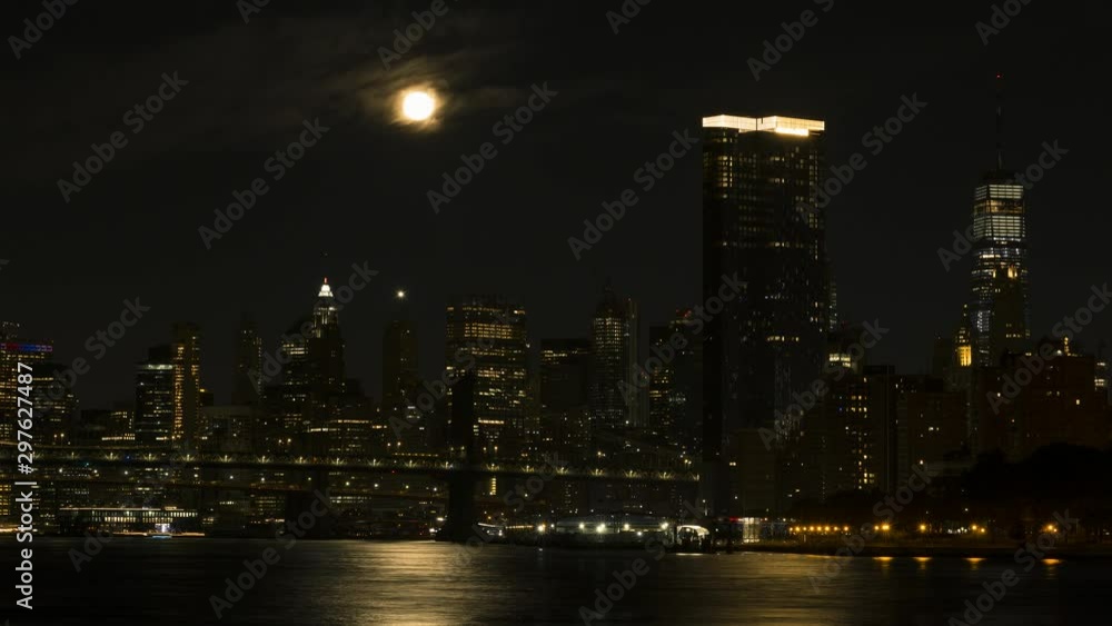 Full moon set over Downtown Manhattan with two bridges, a night to day Time-lapse. Full moon set over Downtown Manhattan with two bridges, a night to day Time-lapse.