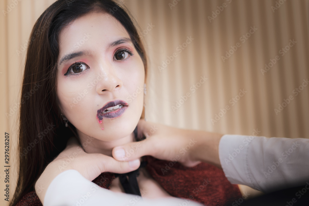 Happy Asian girl vampire is strangled by boy friend. The blood is on the mouth. Halloween party. Happy Asian girl vampire is strangled by boy friend. The blood is on the mouth. Halloween party.