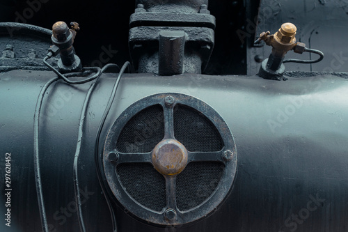 Abstract industrial or transportation or steam punk vintage background with detail of old steam locomotive. 