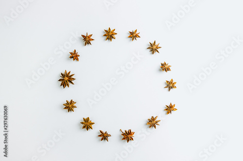 Christmas composition. Wreath made of anise stars on white background. Christmas, winter, new year concept. Flat lay, copy space Christmas minimal concept.