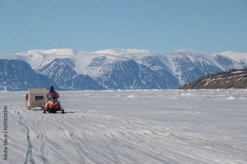Tourists travelling by Qamutiik on the sea ice near Sirmilik National Park in Nunavut, Canada
