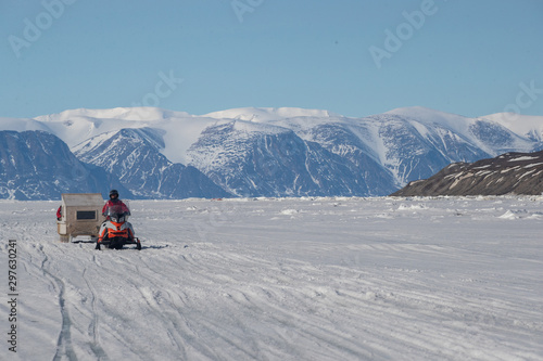 Obraz na płótnie Tourists travelling by Qamutiik on the sea ice near Sirmilik National Park in Nunavut, Canada w salonie