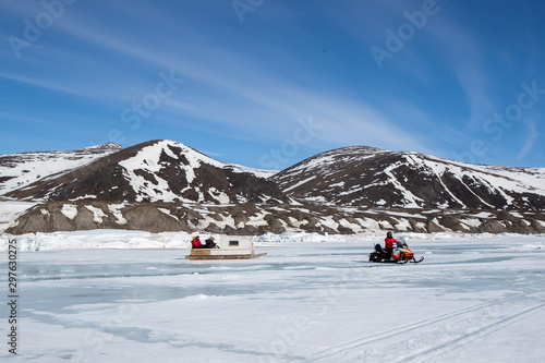 Tourists travelling by Qamutiik on the sea ice near Sirmilik National Park in Nunavut, Canada