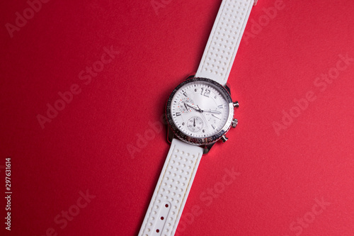 white watch on a red background