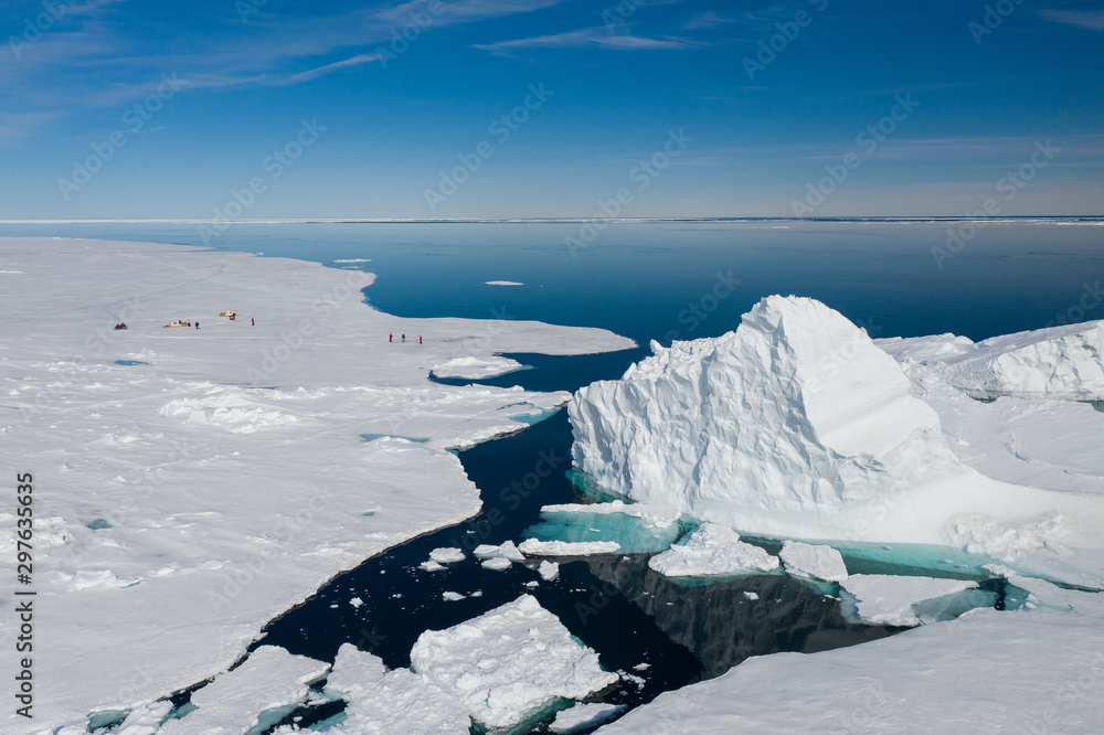 Aerial drone photo of tourists visit the floe edge near Sirmilik National Park in Nunavut, Canadaa