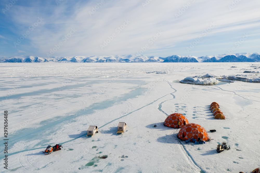 Aerial drone photo of tourists camping on the floe edge near Sirmilik National Park in Nunavut, Canadaa