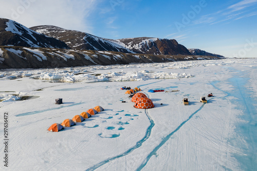 Aerial drone photo of tourists camping on the floe edge near Sirmilik National Park in Nunavut, Canadaa