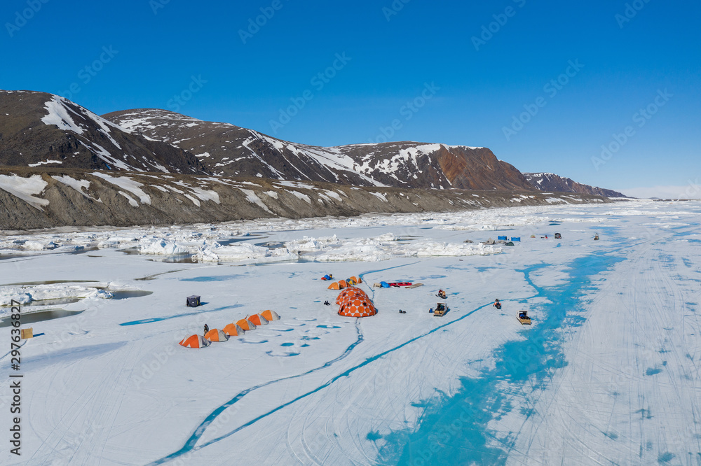 Aerial drone photo of tourists camping on the floe edge near Sirmilik National Park in Nunavut, Canadaa