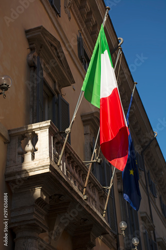 Flag of Italy and European Union on balcony of old building closeup